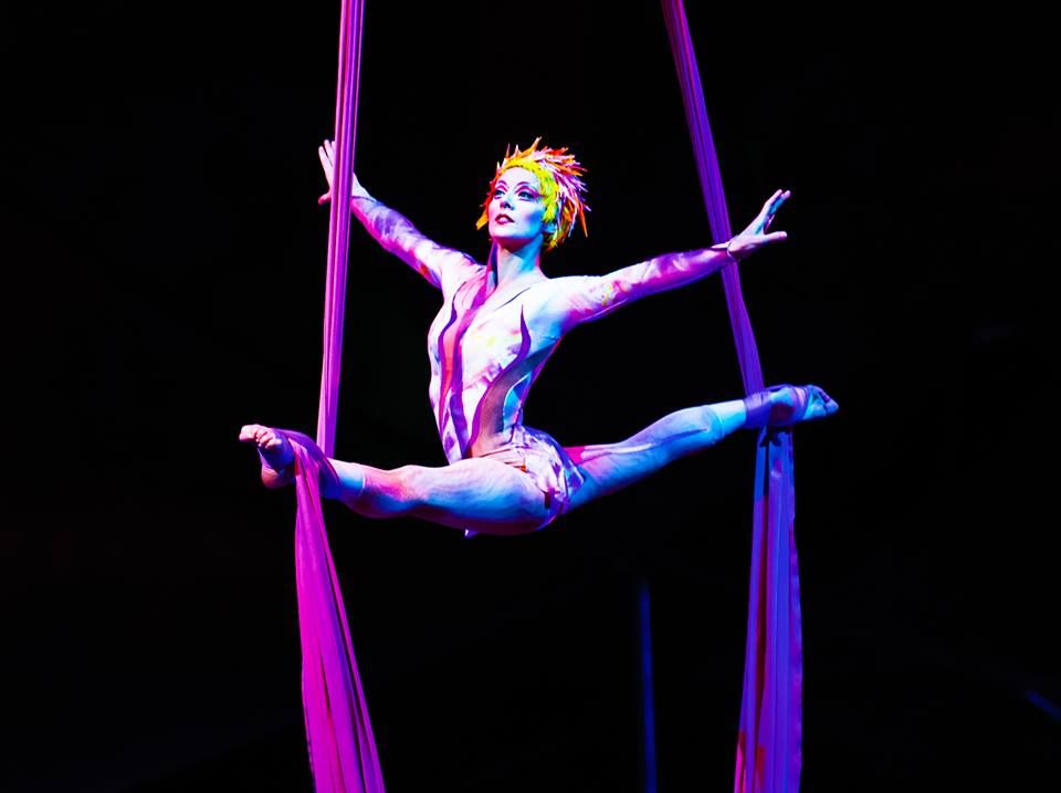 Performer doing a splits in the air on the aerial silks